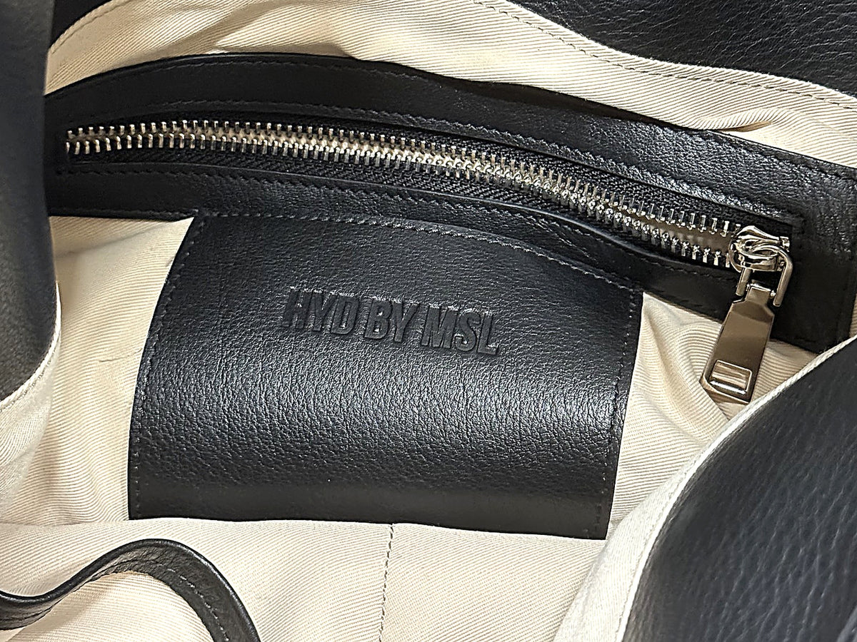 Inside the bag: embossed HYD BY MSL leather patch and zip pocket